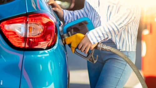 Pumping gas at gas pump. Woman refuel the car.
