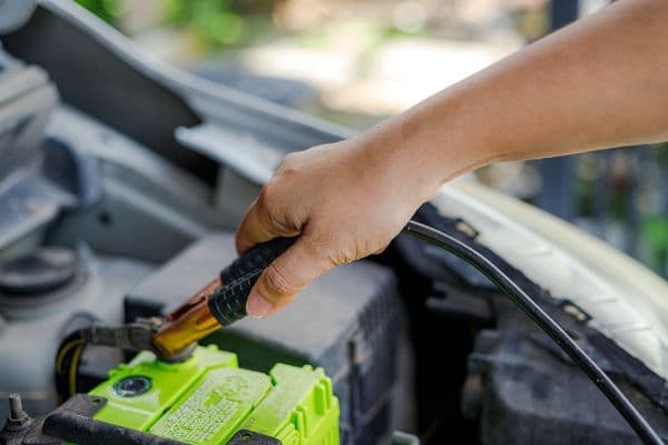 Mechanic conducting a battery replacement test
