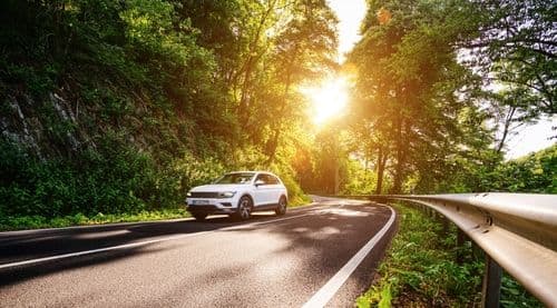SUV driving sunny day