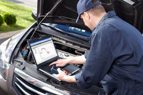 Professional car mechanic working in auto repair service.